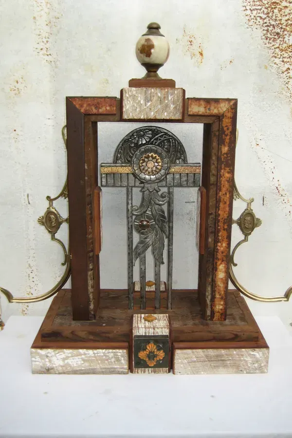 A wooden sculpture with a clock on top of it