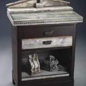 A nightstand with a statue on top of it