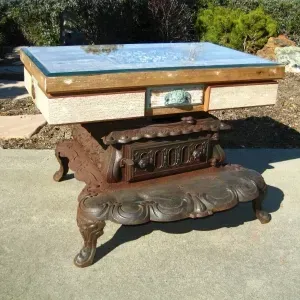 A table with a glass top is sitting on a concrete surface
