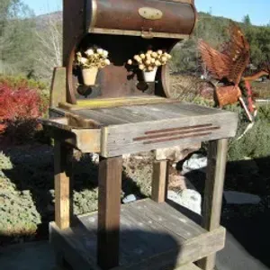 A wooden table with potted flowers on top of it