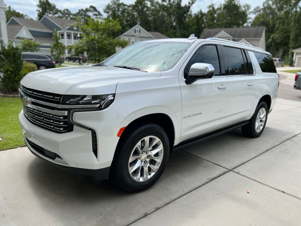 Image of a white SUV with clean detailing parked on a sunny day.