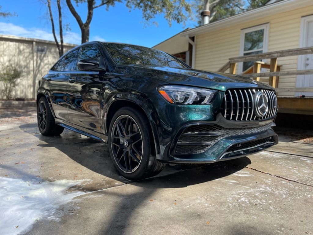 Image of a black SUV showcasing its detailed finish, parked near a building.