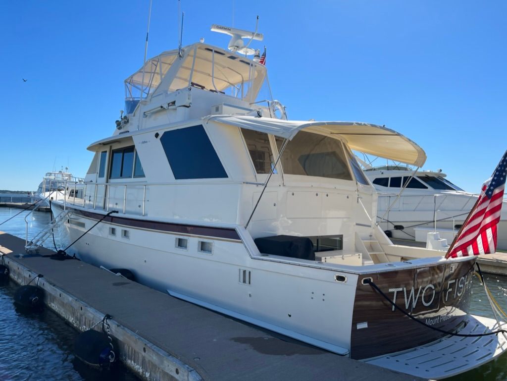 Image of a boat docked with American flags, showcasing marine detailing services.