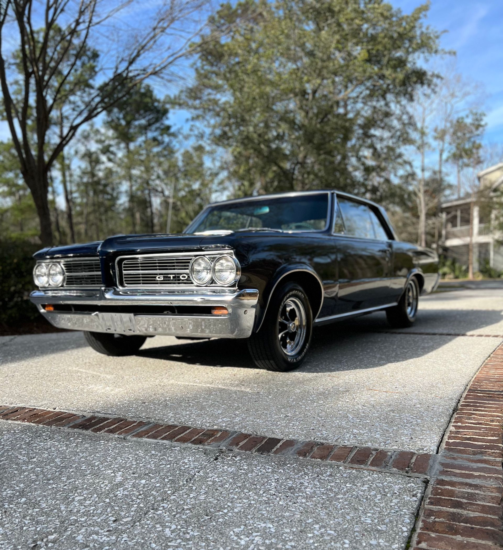 Image of a black classic car with a detailed and polished finish.