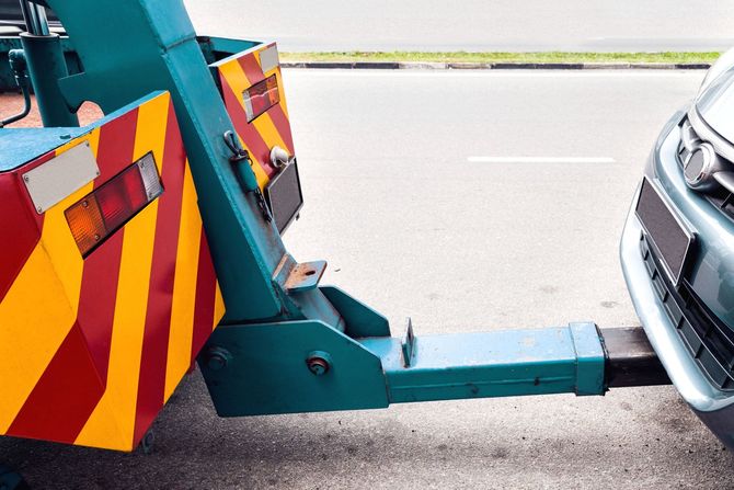 Tow truck delivers the damaged vehicle Tow truck delivers the damaged vehicle