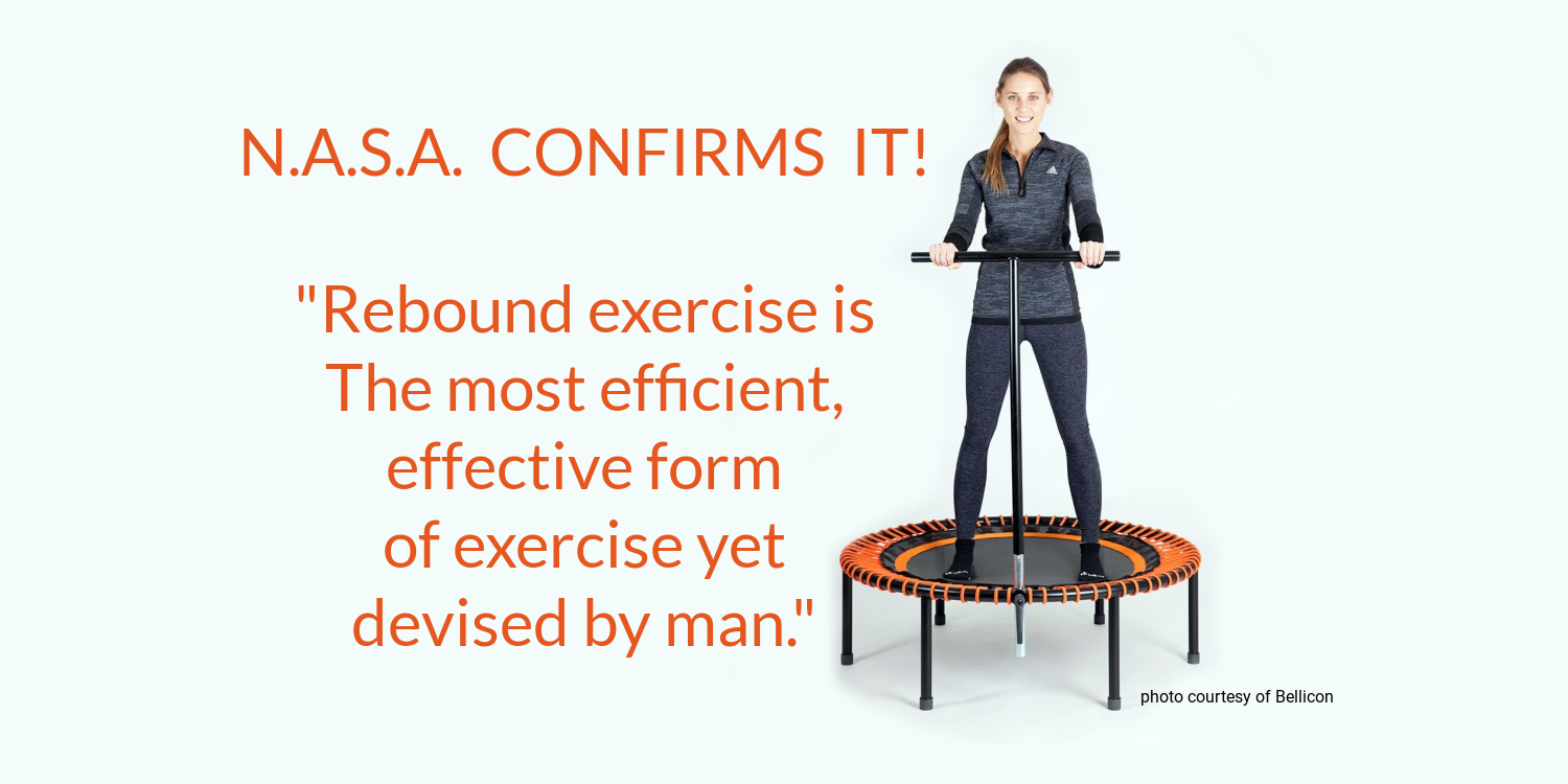 A woman is standing on a rebounder trampoline with a handle.