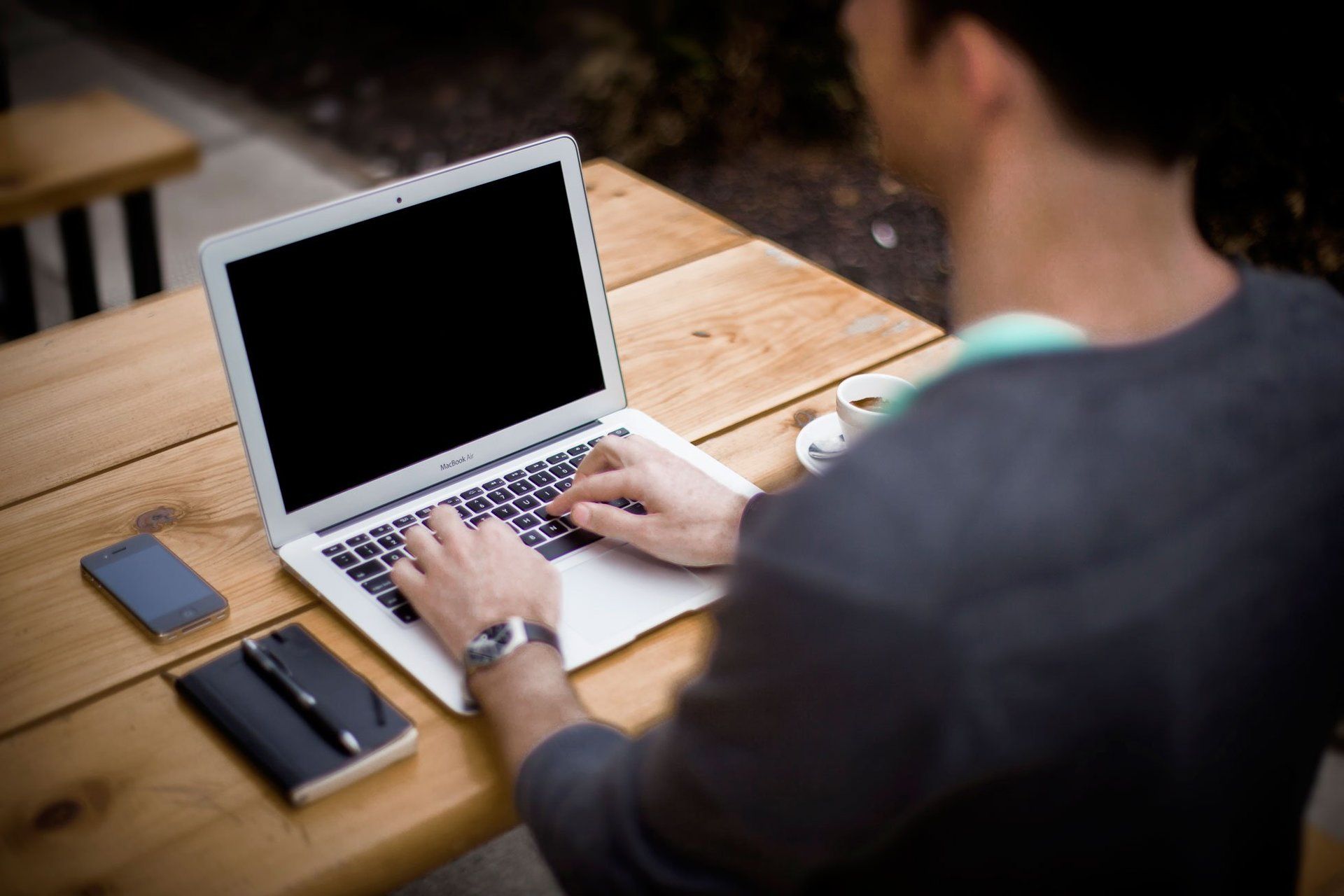 A man typing on a laptop at a desk