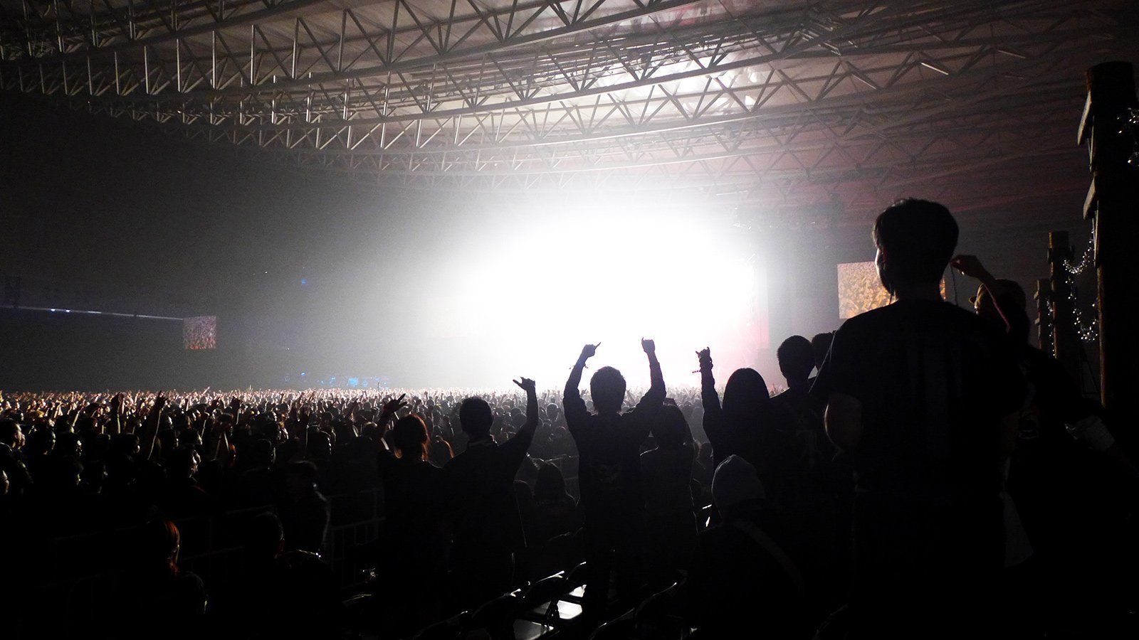 a crowd of people are standing in front of a stage at a business summit