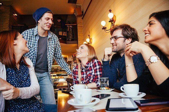 restaurant owner and diners at a table