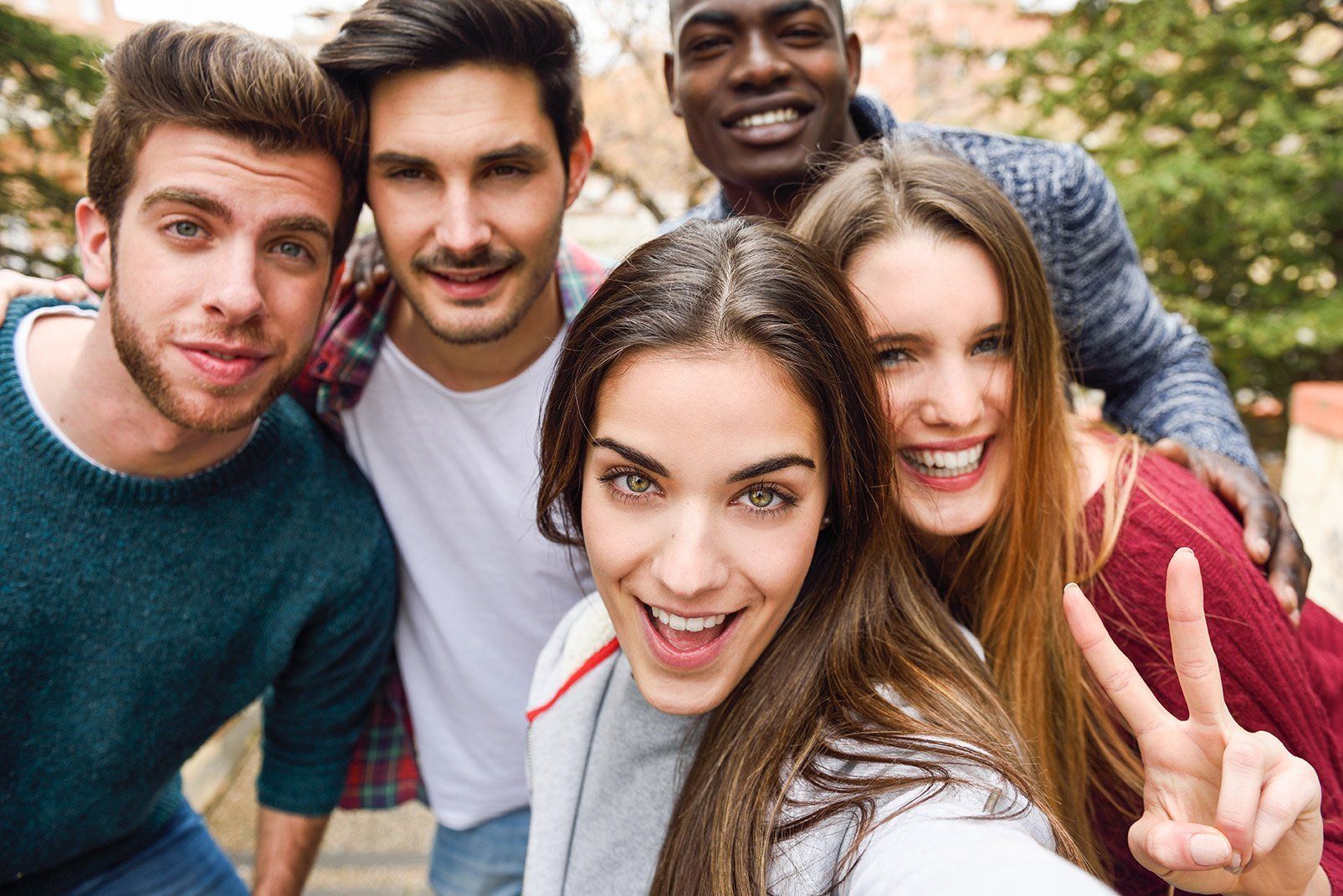 a group of young people are taking a selfie together .