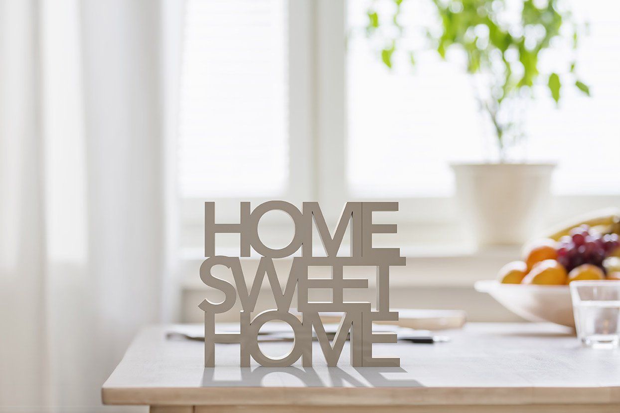 a wooden sign on a table that says `` home sweet home '' .