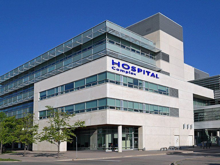 Large hospital showring the front door and front of building