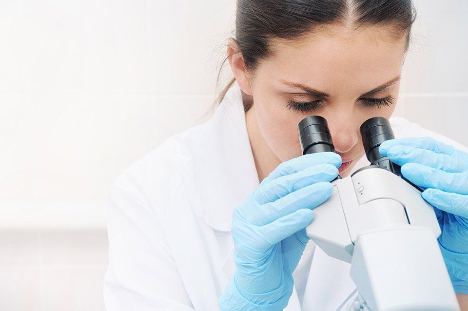 Person looking through a microscope DCRT