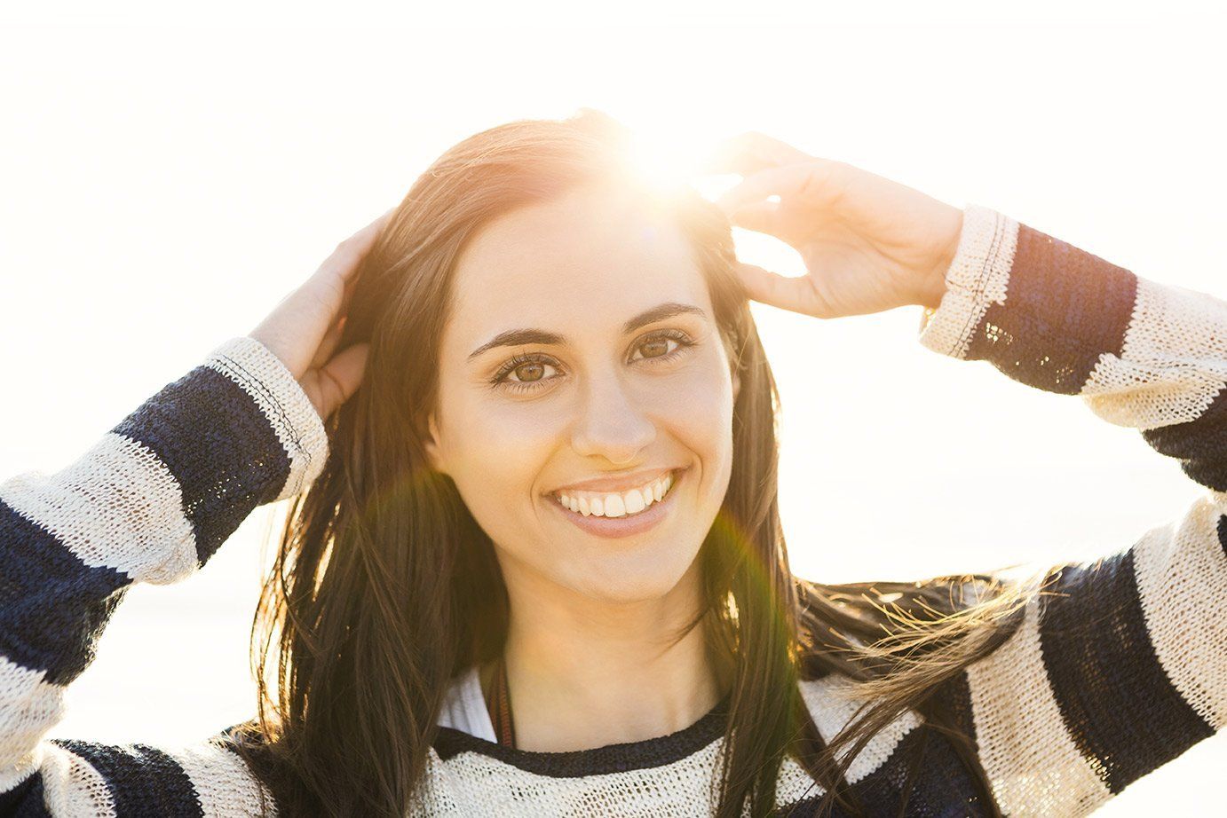 woman smiling in the sun | teeth whitening Richmond and lawson mo