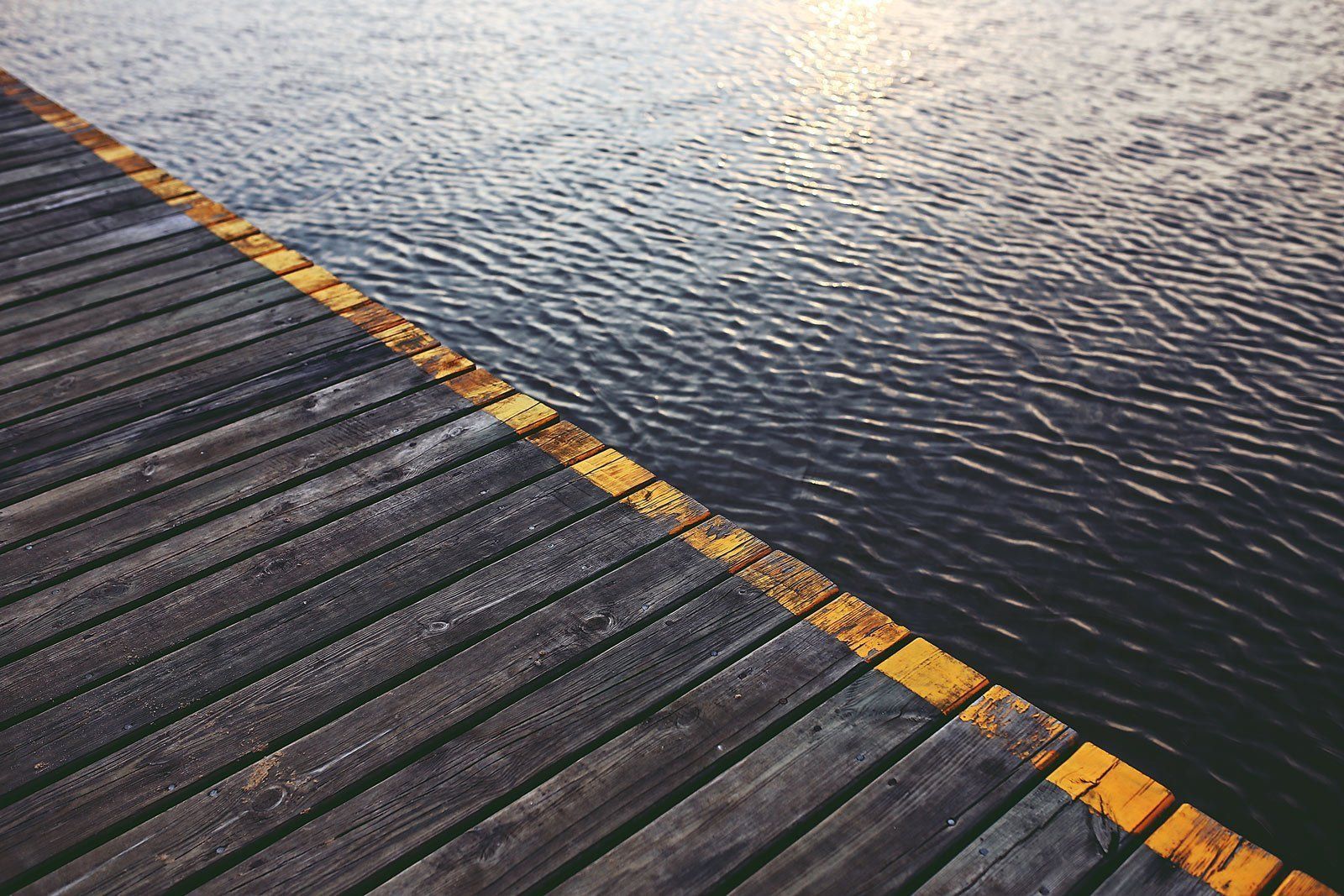 A wooden dock leading to a body of water.