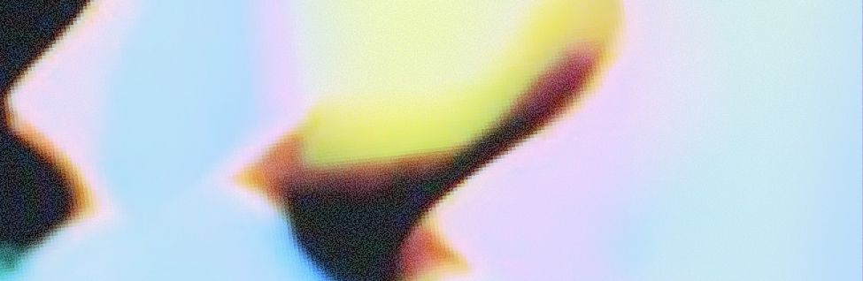 Abstract close-up of a colorful blurred shape with pastel blue, yellow, and dark tones