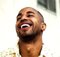 Smiling man showcasing healthy, white teeth after dental treatment.