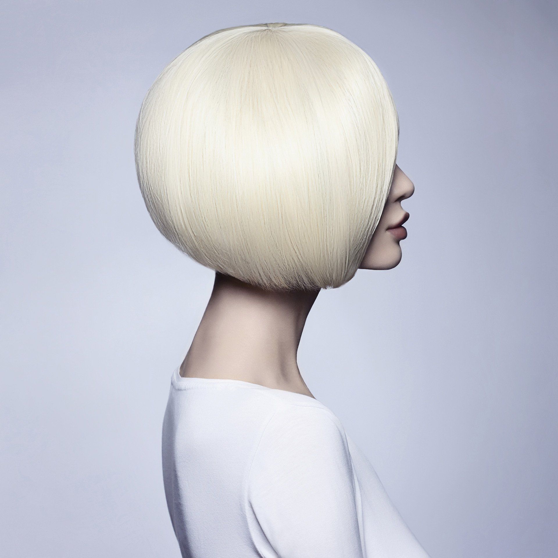 A woman with a stylish short blonde bob, showcasing Mokara Solutions' focus on hair and skin wellness.