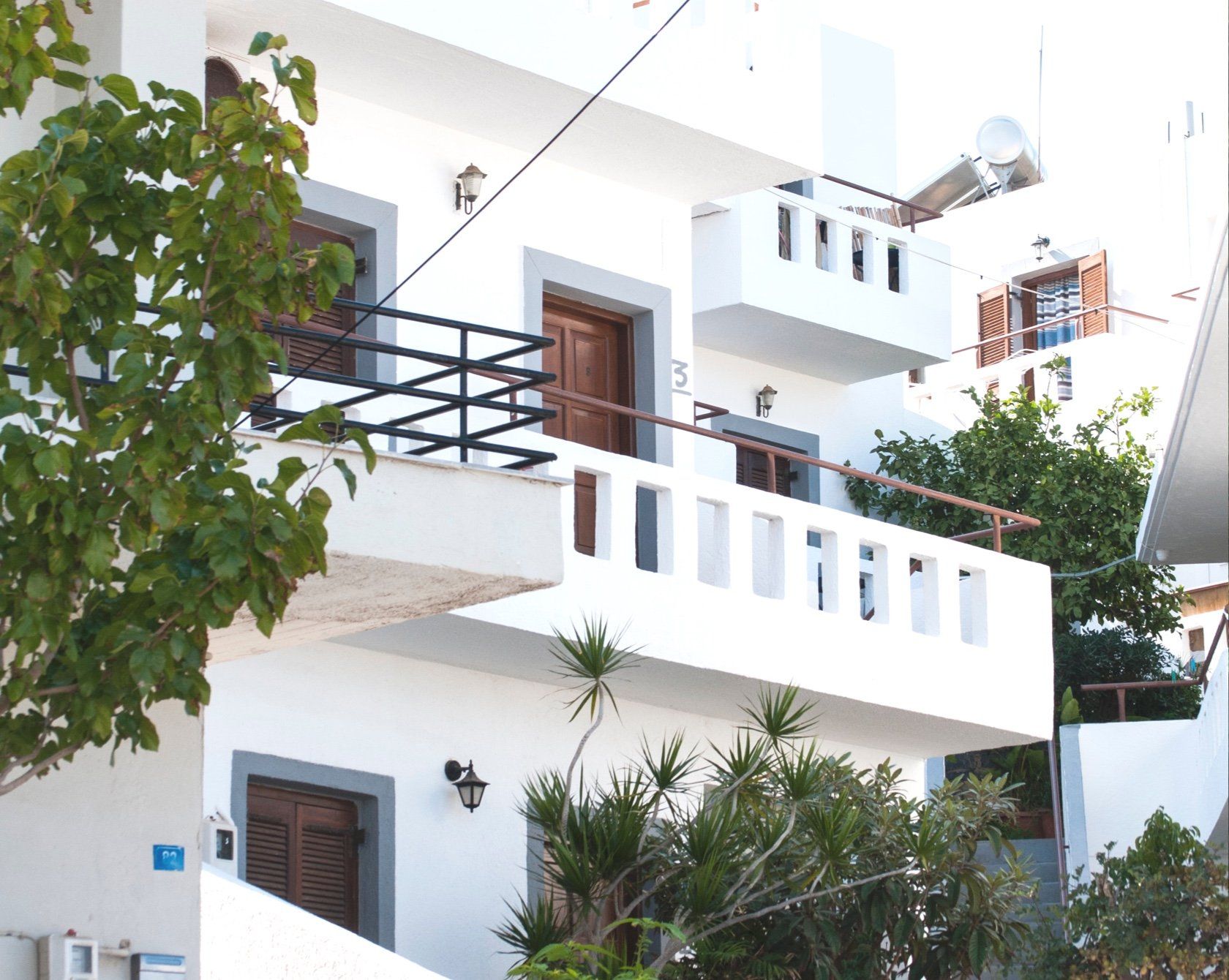 A white building with a balcony on the second floor