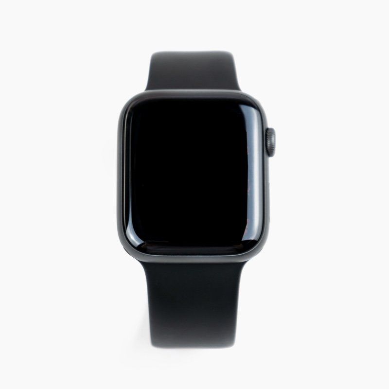 A black apple watch with a black band on a white background.