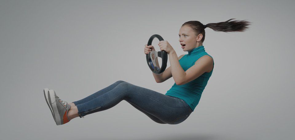 A woman is flying through the air while holding a steering wheel.