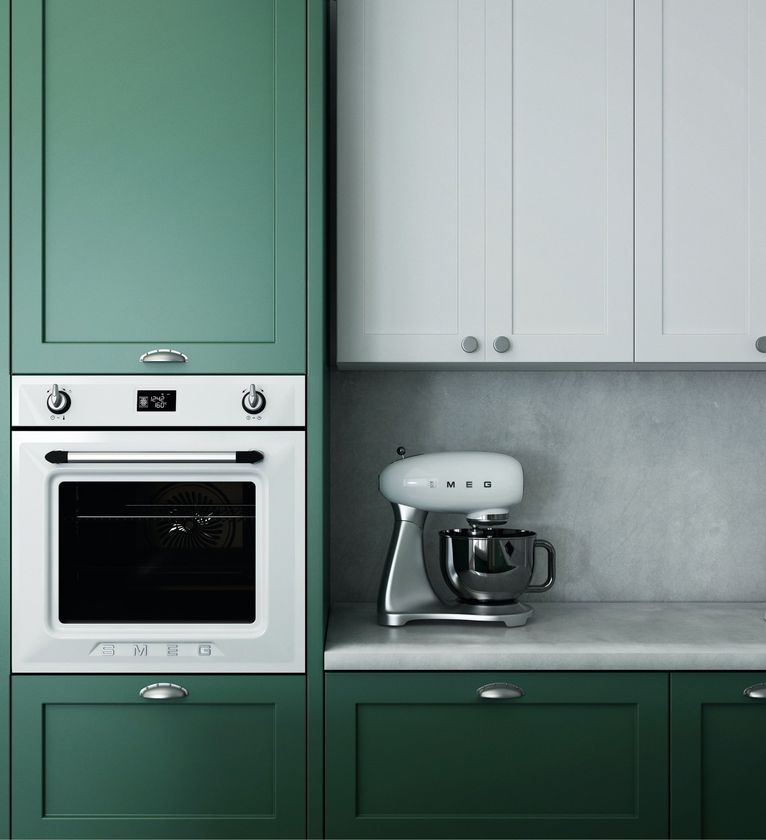 A kitchen with green cabinets and a white mixer