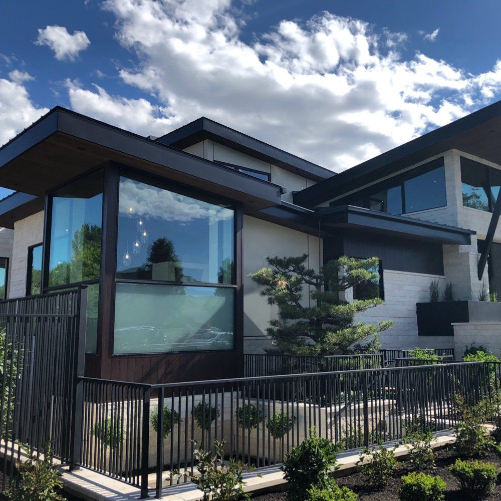A large house with lots of windows and a fence around it