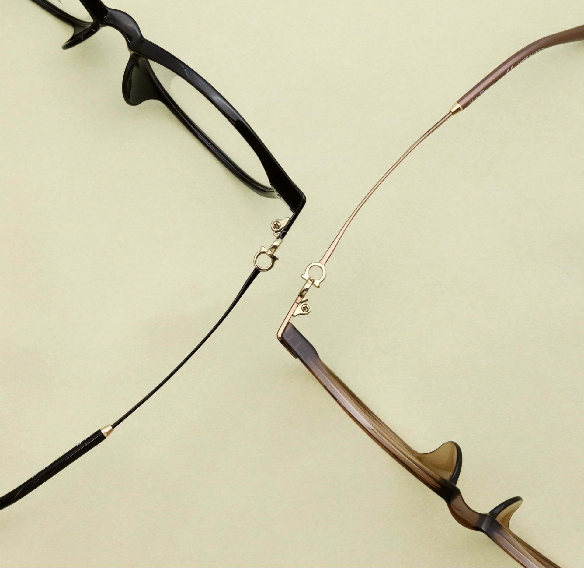 A pair of glasses laying on a beige surface