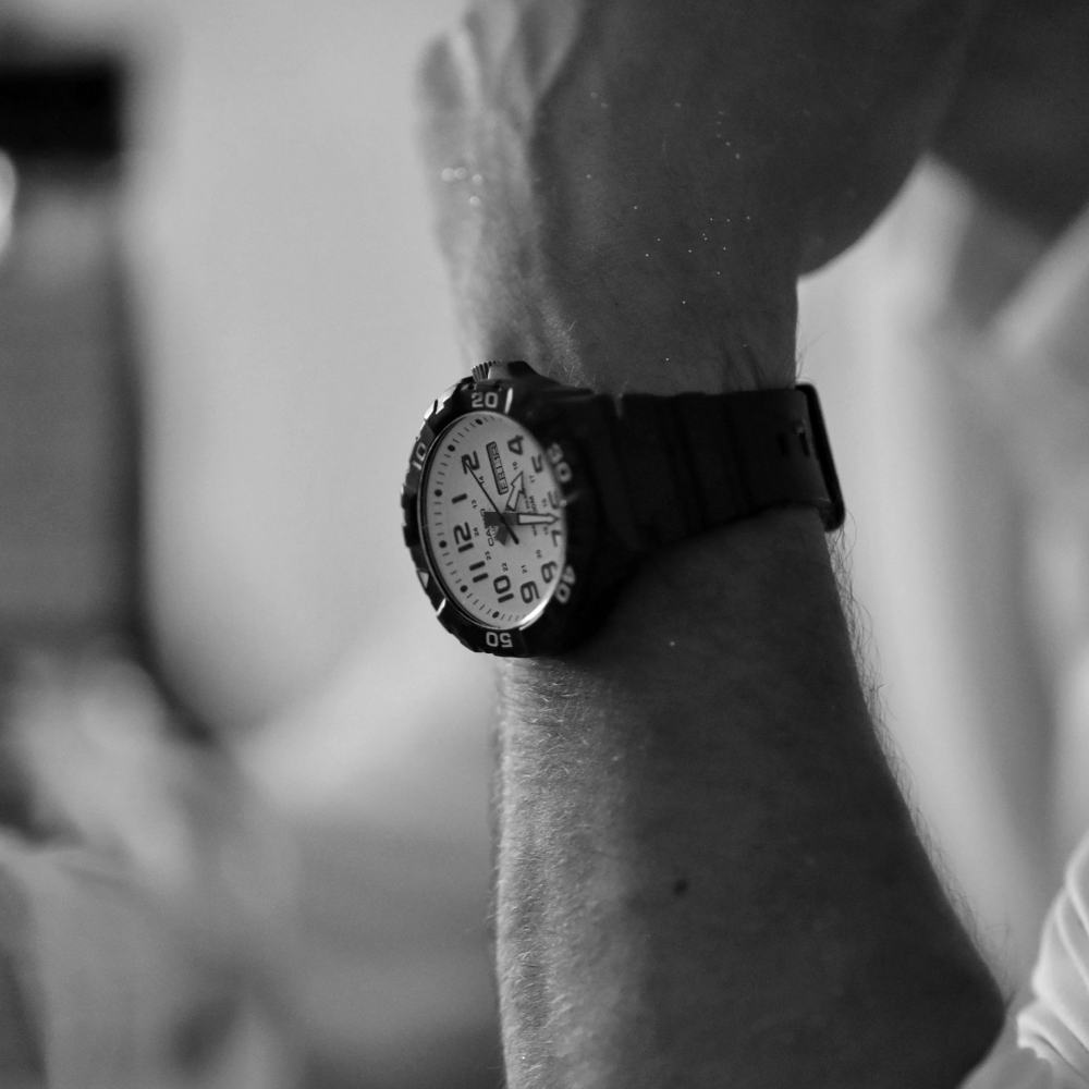 A black and white photo of a person wearing a watch