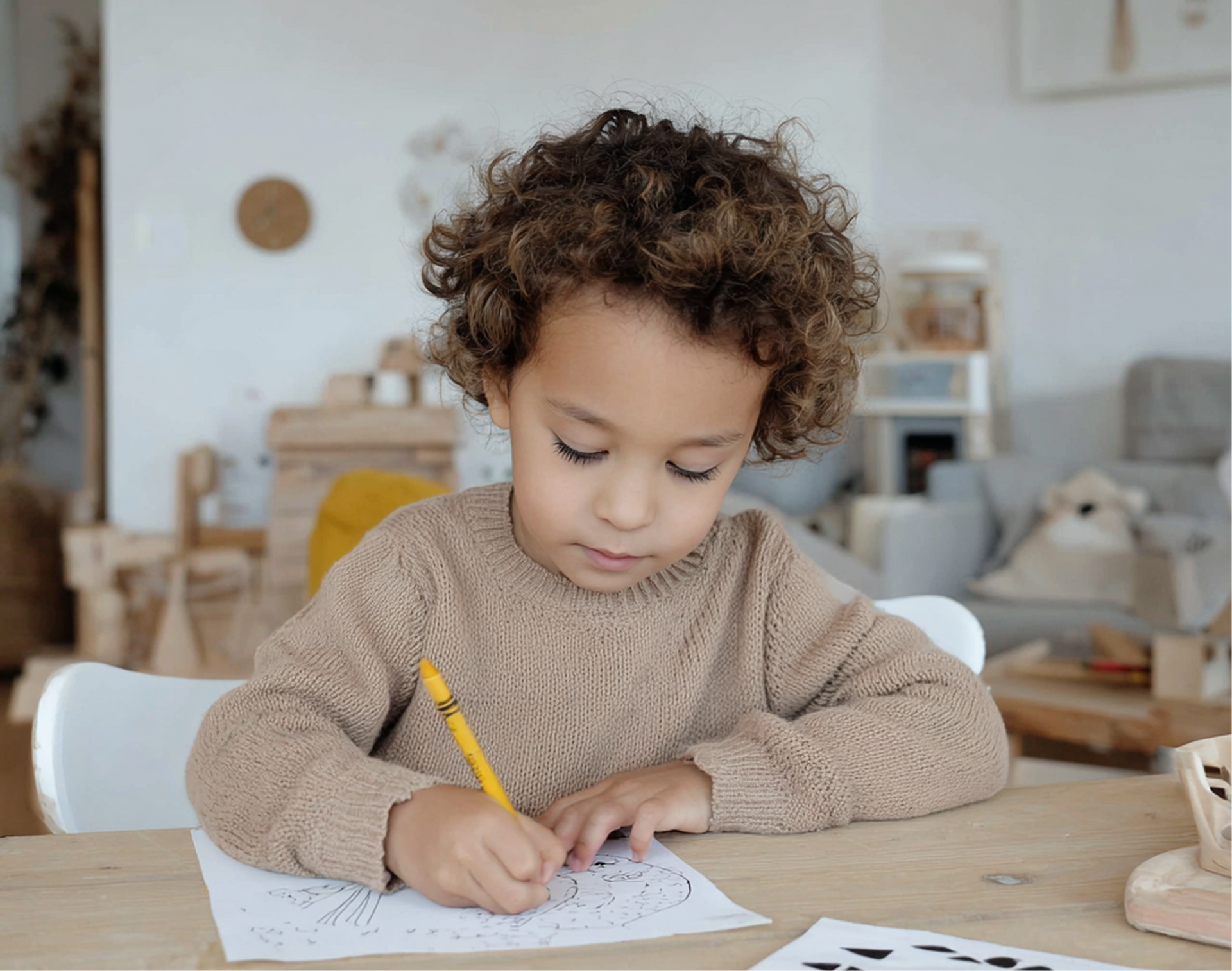 boy drawing with crayons in a safe environment