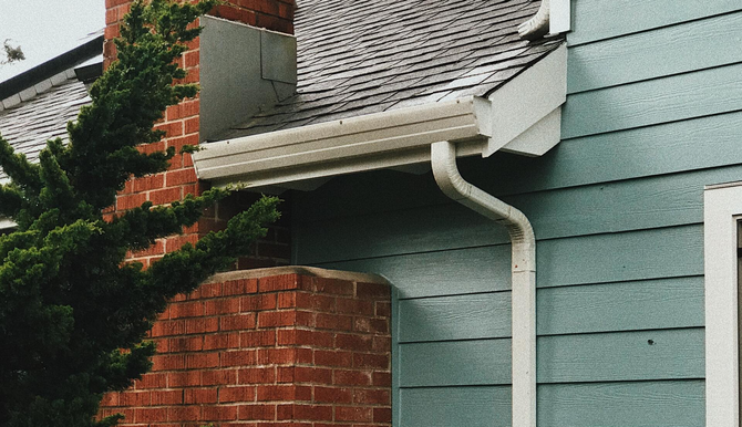 A flat roof with chimneys and a smooth black finish