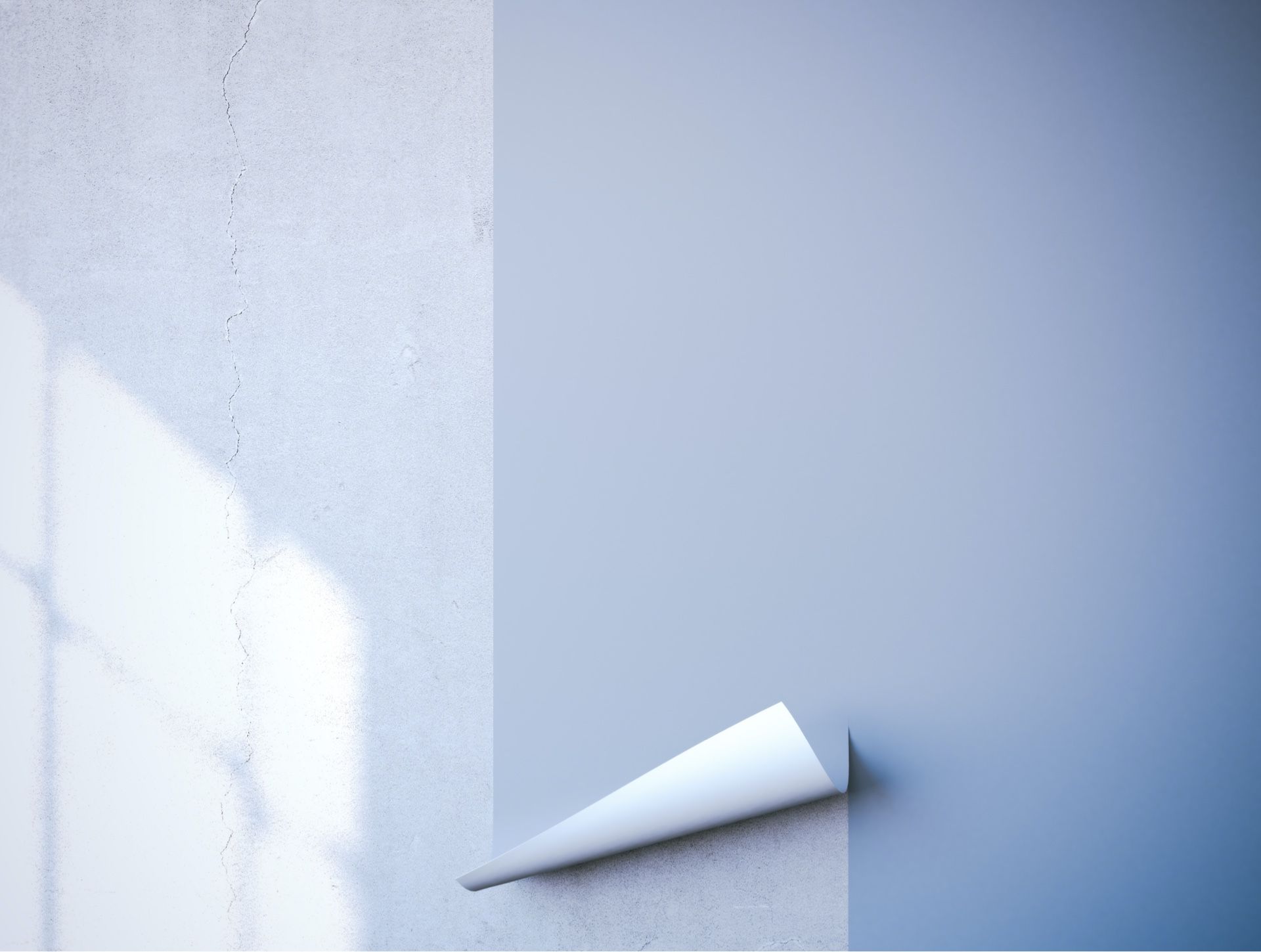 Wall with blue paint partially peeled back, revealing a textured, light gray surface.