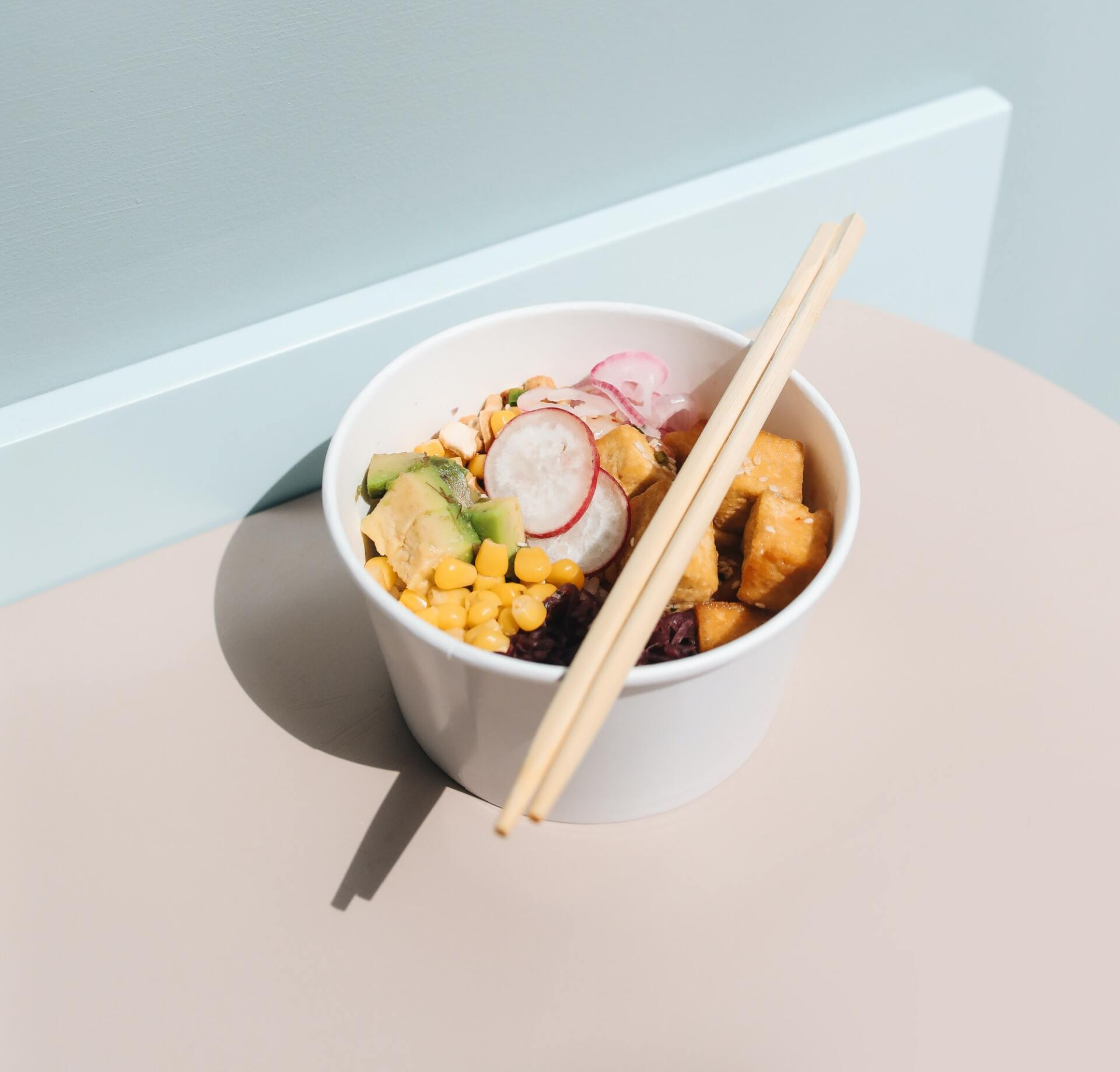 A bowl of food with chopsticks in it on a table