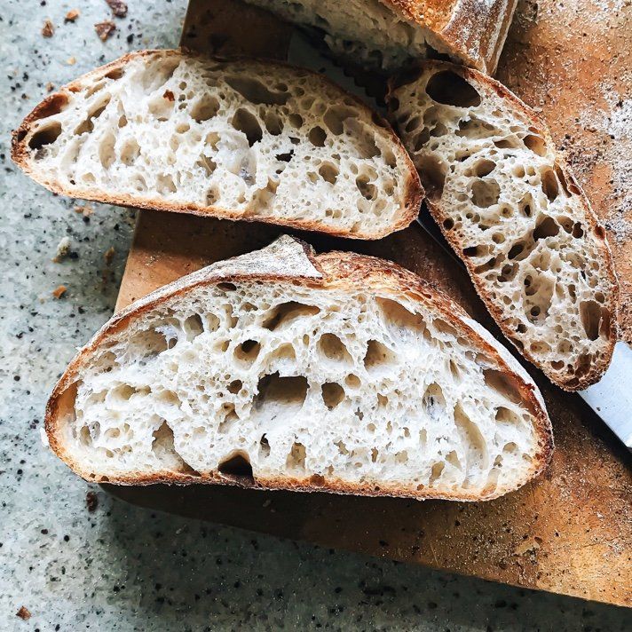 Three slices of bread are on a wooden cutting board