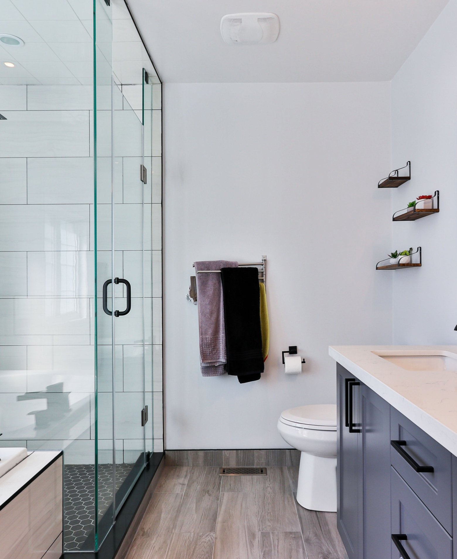 A bathroom with a toilet a sink and a shower