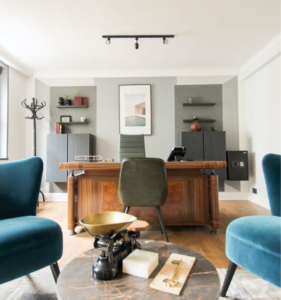 A living room with two chairs and a desk
