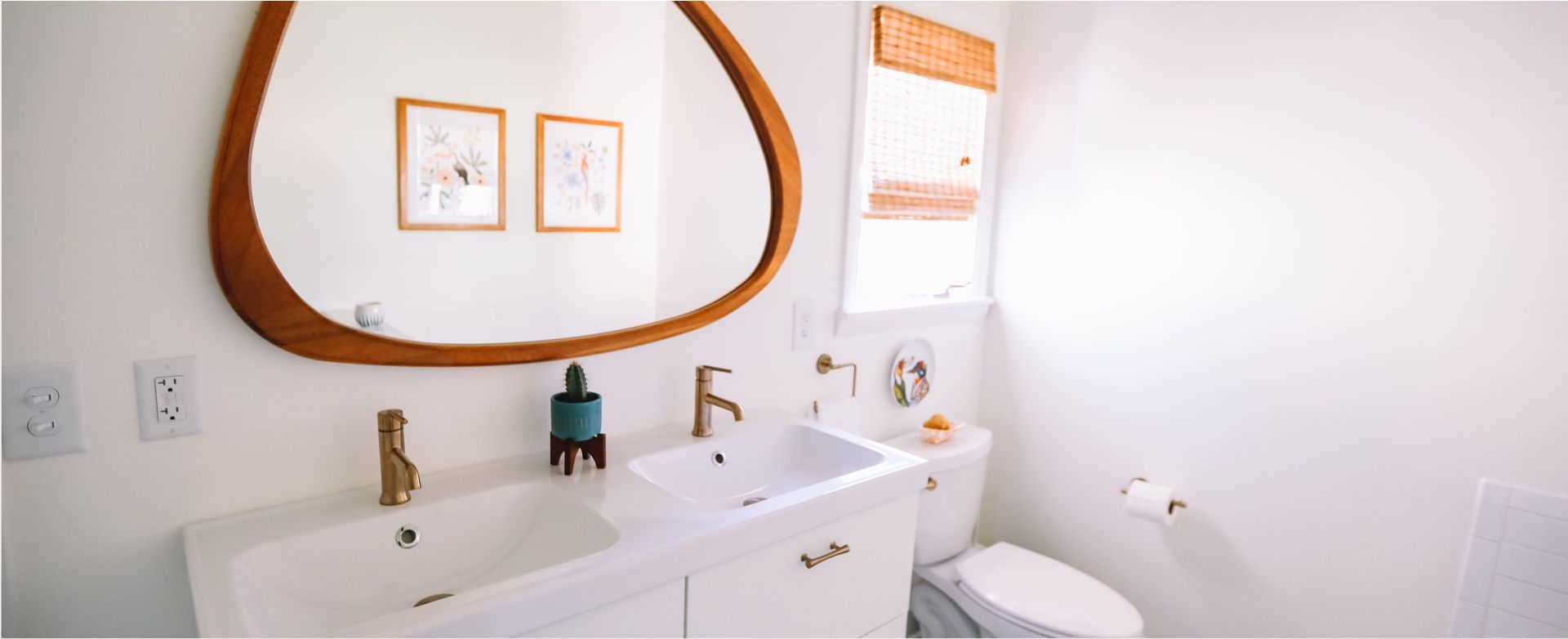 A bathroom with a sink , toilet and mirror.