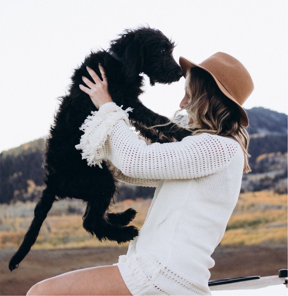Image of a woman with her black dog