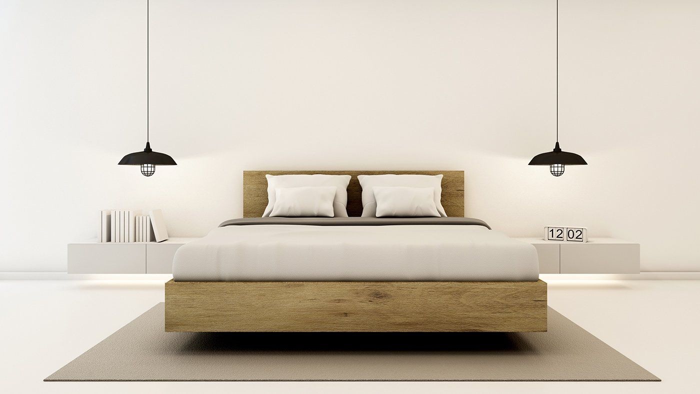 Um quarto com cama, mesinhas de cabeceira, candeeiros e tapete.