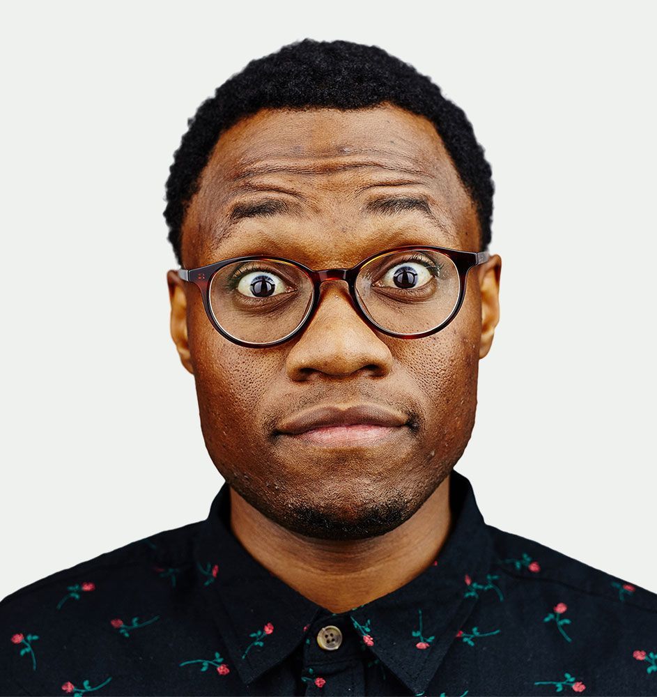 A man wearing glasses is making a funny face