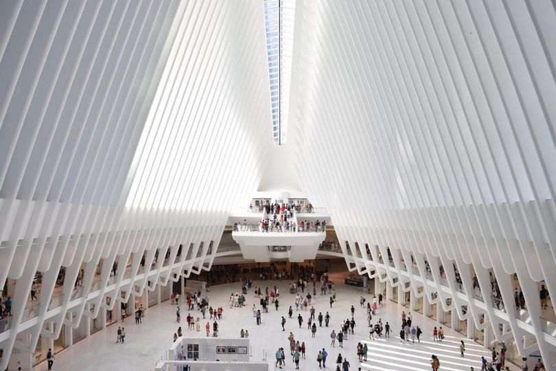 A large white building with a lot of people in it