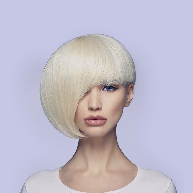 A woman with blonde hair and blue eyes is wearing a white shirt.
