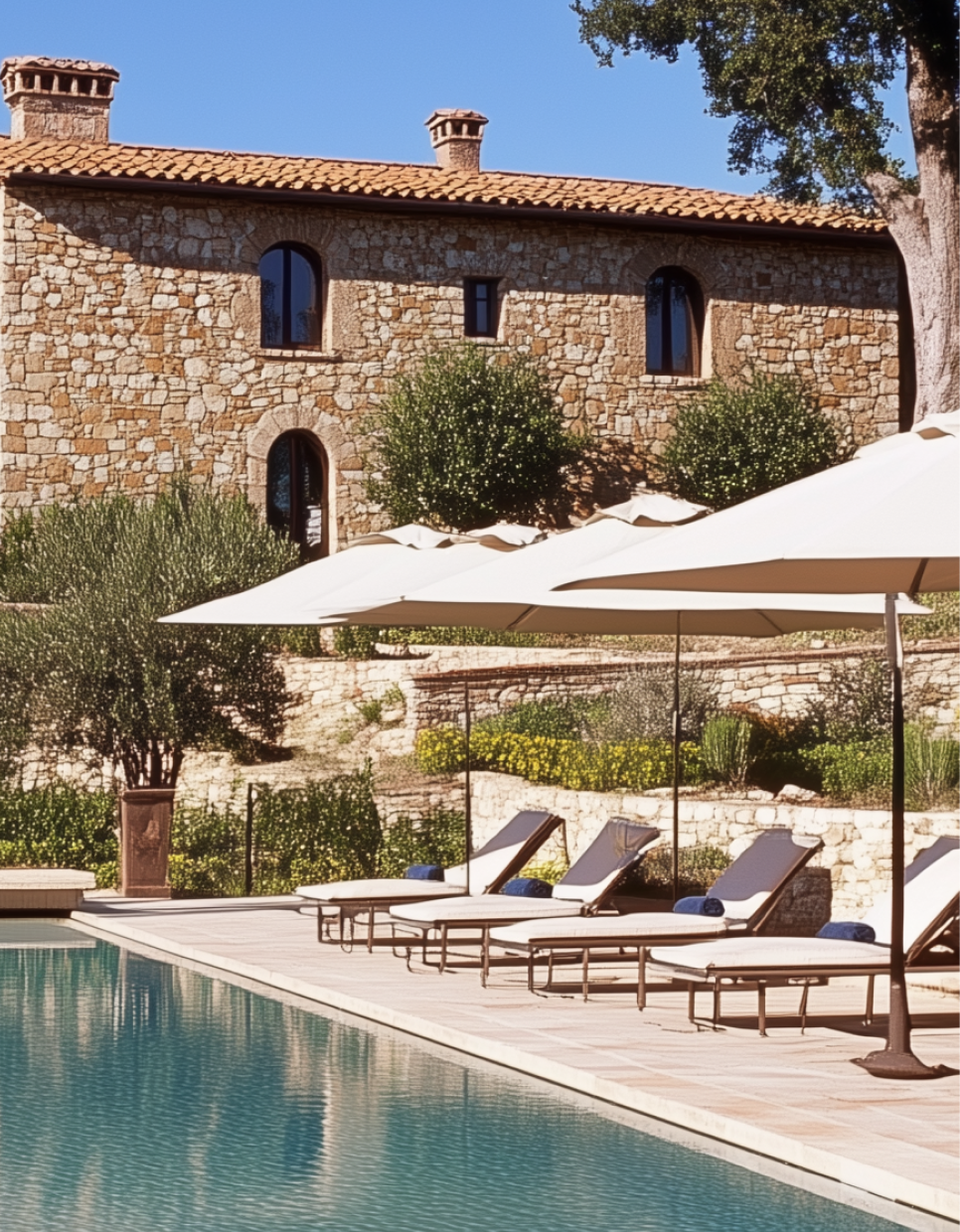 A large stone building with a swimming pool in front of it
