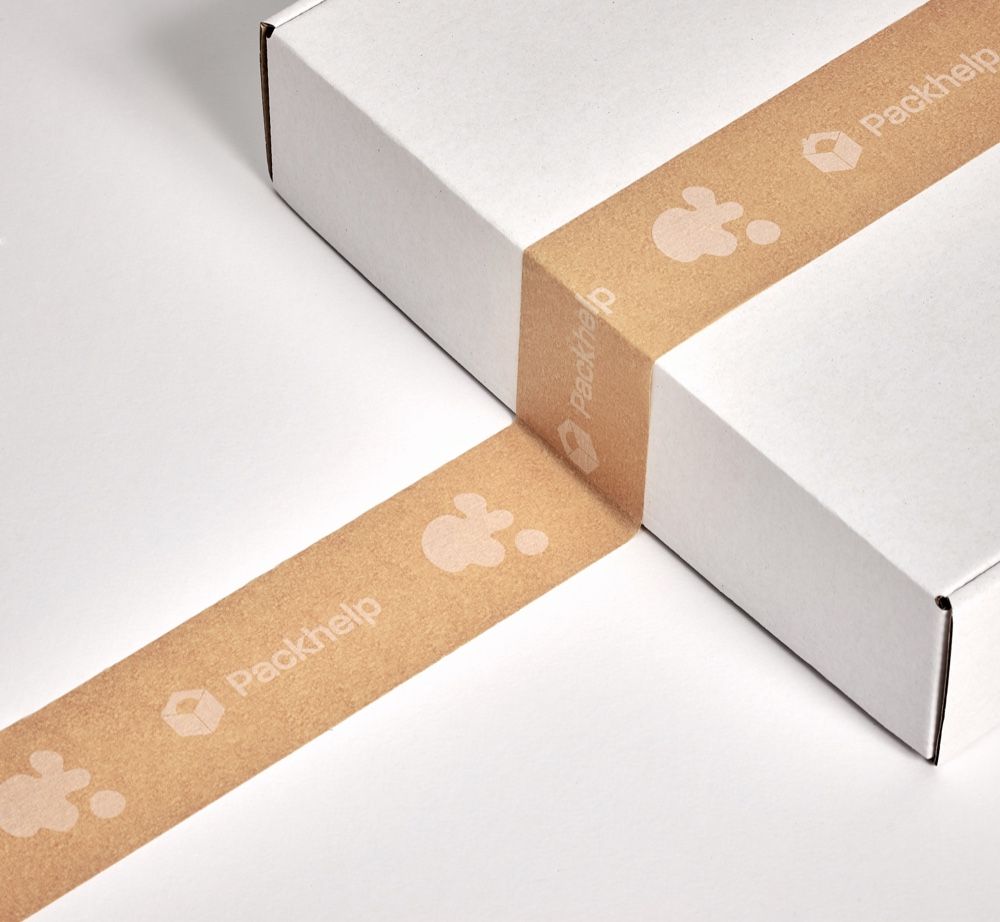 A plain white cardboard box wrapped with branded brown paper tape labeled 