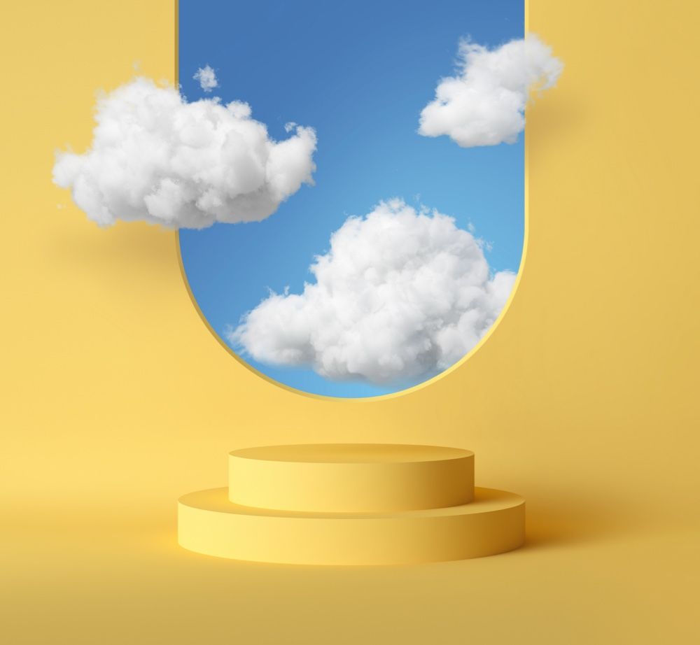 A yellow two-tiered pedestal stands before an arched window showing a bright blue sky with fluffy white clouds.