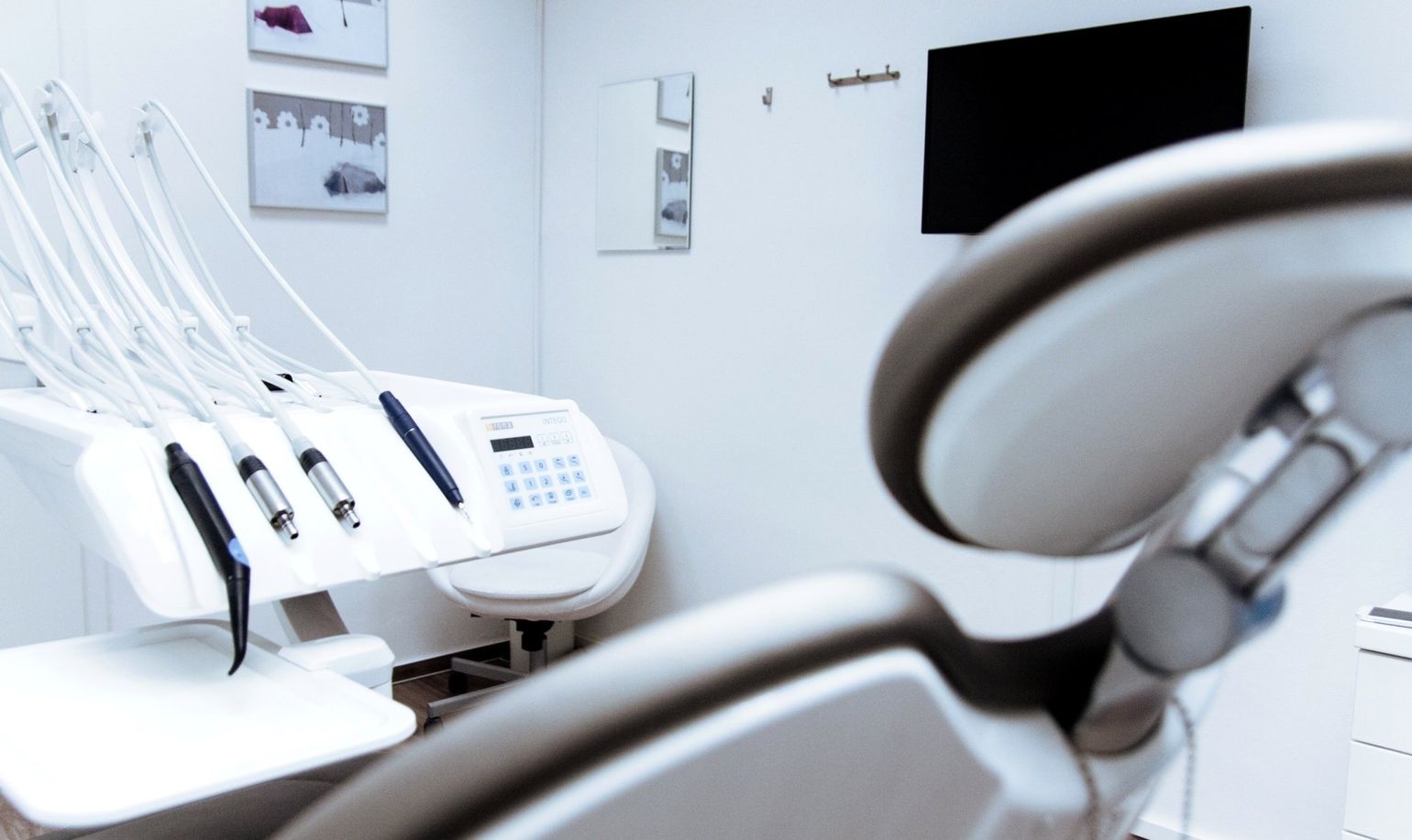 An empty dental chair in a dental office.