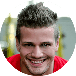 A man in a red shirt is smiling in a circle