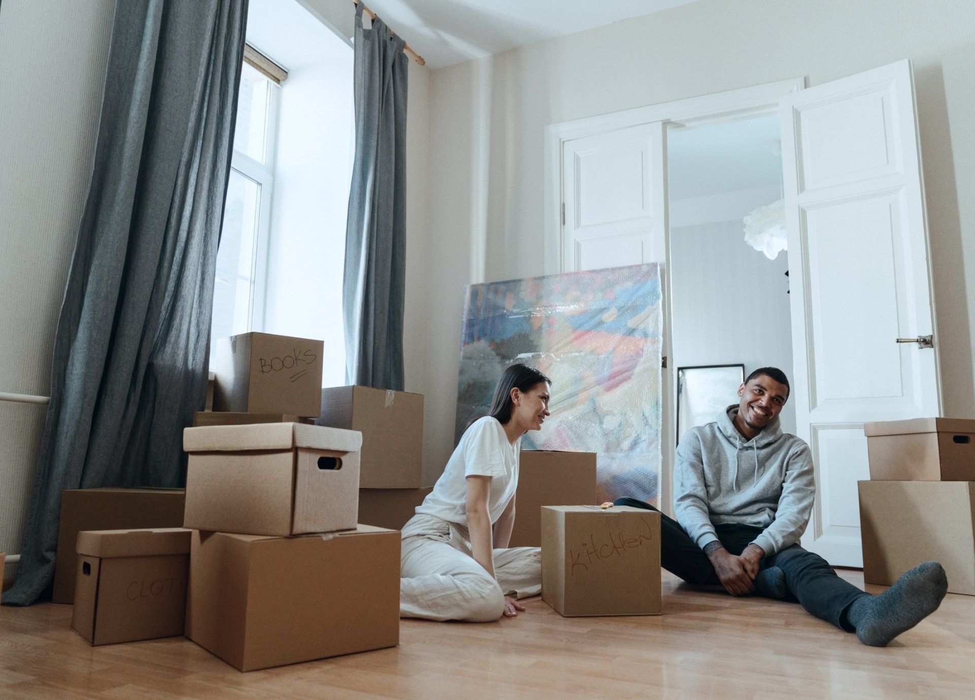 Couple moving and packing boxes in their home