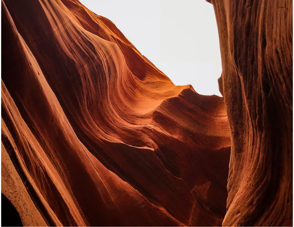 A close up of a canyon with a white sky in the background