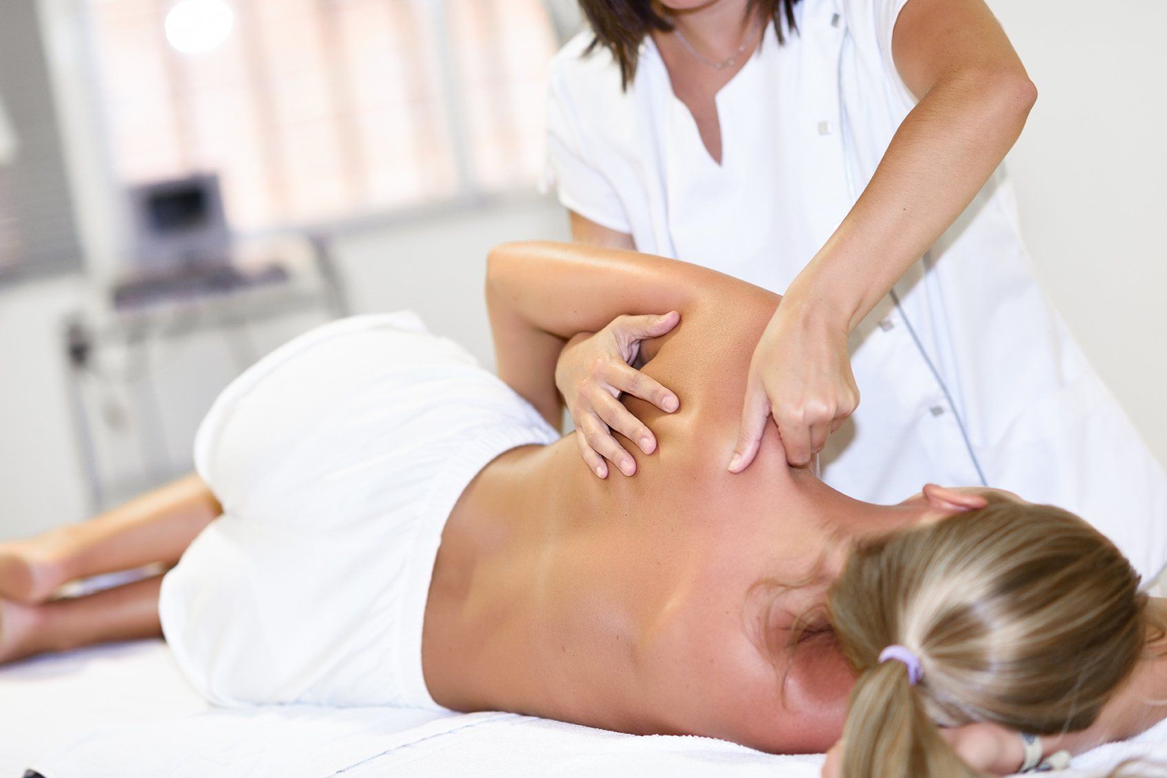 A woman is getting a massage on her back in a spa.